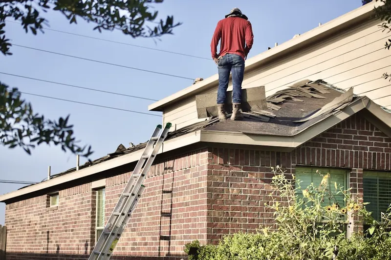 Professional roofer working on a residential roof in Encore at Monroe